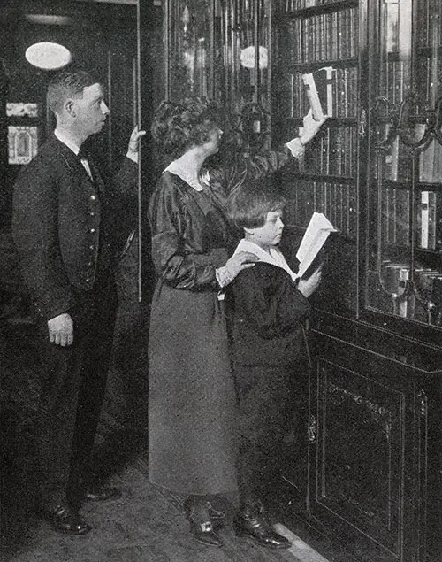 First Class Passengers Select Reading Materials from the Library on a White Star Line Steamship circa 1909.