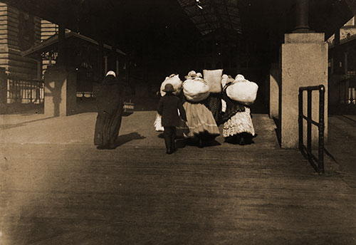 Immigrants Carrying Luggage at Ellis Island. nd, circa 1912.