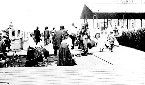 Ellis Island Dock with Immigrants in Foreground. nd circa 1910s.