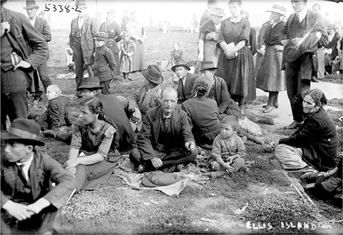 Group of Immigrants Gathered on Lawn at Ellis Island circa 1910.