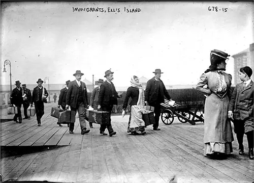 Immigrants at Ellis Island Carrying Luggage. nd. George Grantham Bain Collection. Early 1900s.