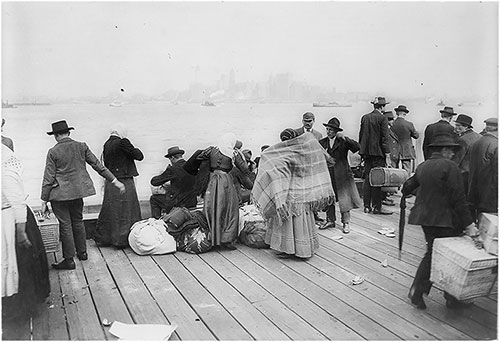 Immigrants Waiting at the Dock at Ellis Island to be Transferred.