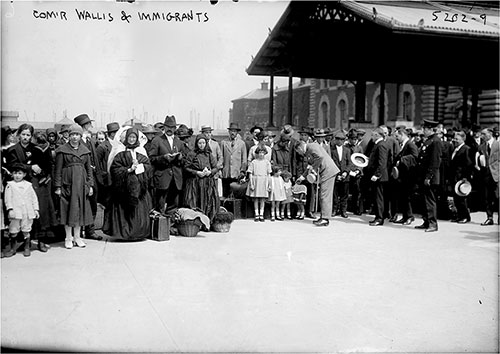 Ellis Island Commissioner, Frederick Wallis Visits with a Group of New Immigrants at Ellis Island, June 1921.