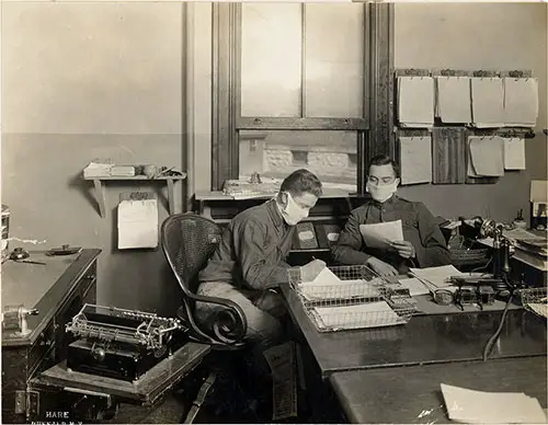 Persons of the Office Force Used Masks at Work. Showing Dictation Being Giving Through the Masks.