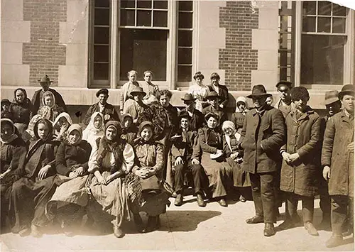 Group of Immigrants Outside a Building at Ellis Island. nd, circa 1912.