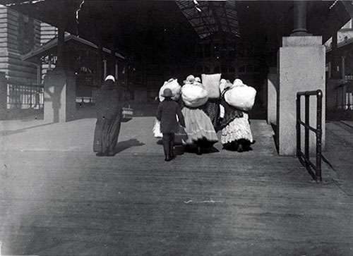 Immigrants Carrying Luggage at Ellis Island. nd, circa 1912.