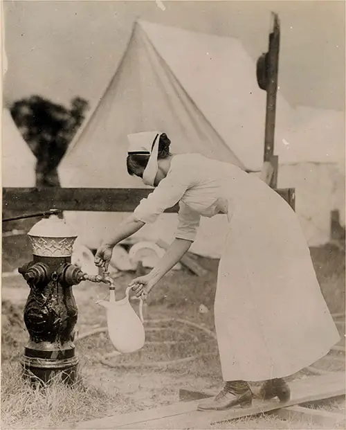 Nurse Wearing a Mask as a Protection Against the Disease, Which Is Contagious, Filling Pitcher From Water Hydrant.