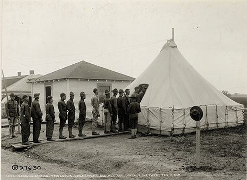 Soldiers Line Up at the Spraying Station at Love Field in Dallas Texas 6 November 1918.