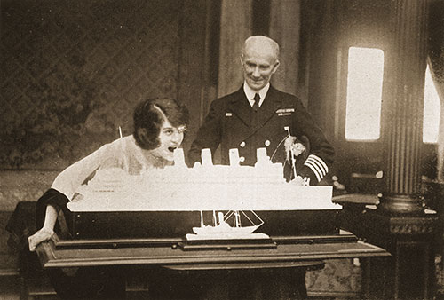 Passenger Takes the First Bite of a Sugar Model of the Aquitania Made by the Ship's Confectioner.