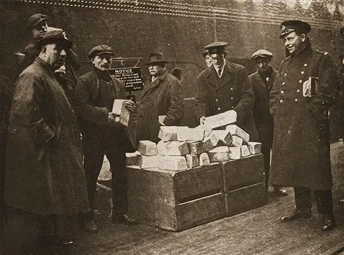 Aquitania Discharges a Valuable Cargo of Silver Bars.