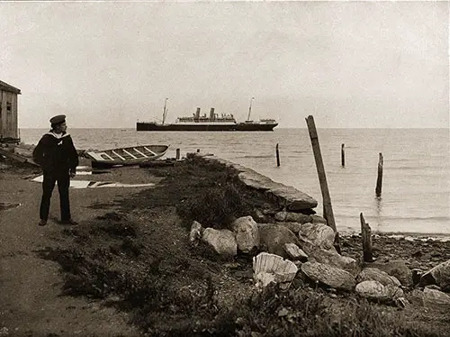 The SS Blücher Seen from the Shoreline in Trondhjem harbor - Norwegian Sailor in Foreground.