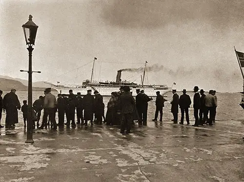 A Crowd Gathers at the Pier Watching the SS Meteor at the Pier at Aalesund.