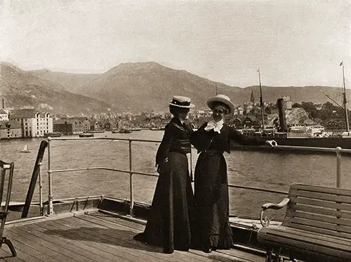 View of the SS Meteor and Two Well-Dressed Women in the Foreground on the Pier in Bergen, Norway.
