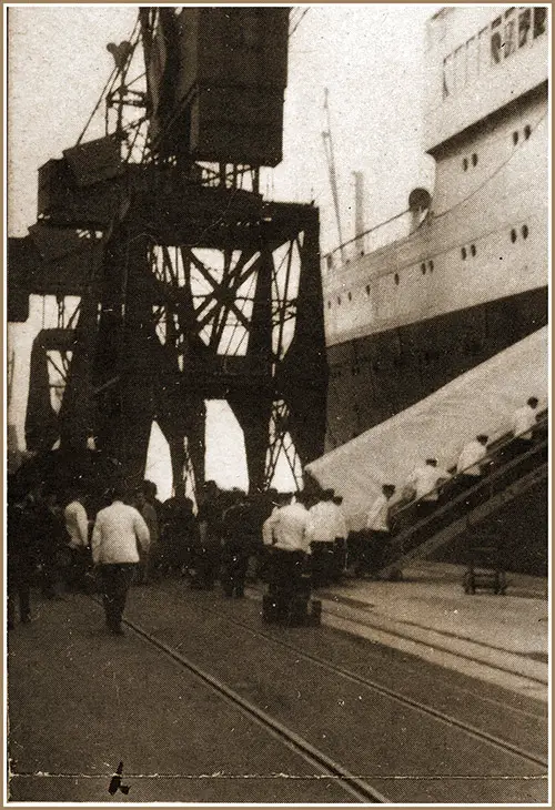 Small Army of White-Coated Men Are the Ship's Stewards Putting Luggage on Board to Be Delivered Directly to Your Stateroom.