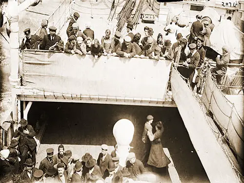 Third Class Passengers Dancing while Second Class Passengers on the Deck Above Watch on the SS Kaiserin Auguste Victoria, c1910.