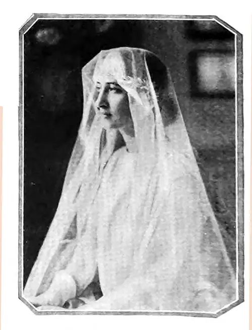 The Wedding Coiffure of Today Scorns Tradition and Seeks Individuality. Thus Mlle. Gisele Cahen-Fuzier Completes Her Botticelli Gown With a Veil of Florentine Draping and a Crown of Silver Laurel Leaves. Vogue Magazine, 1 April 1922.
