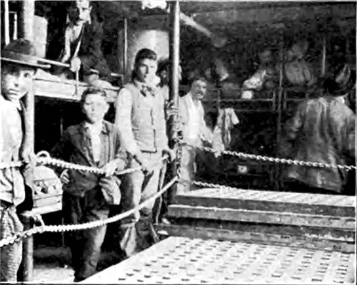 The Men's Sleeping Quarters in Steerage, Showing Arrangement of Bunks and Baggage in Bed with Occupants.