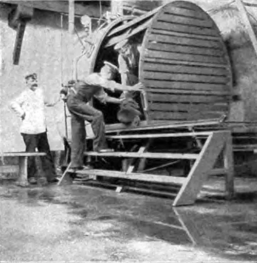 The Big Steam-Box in Which the Outer Clothing of the Immigrant Undergoes Disinfection.
