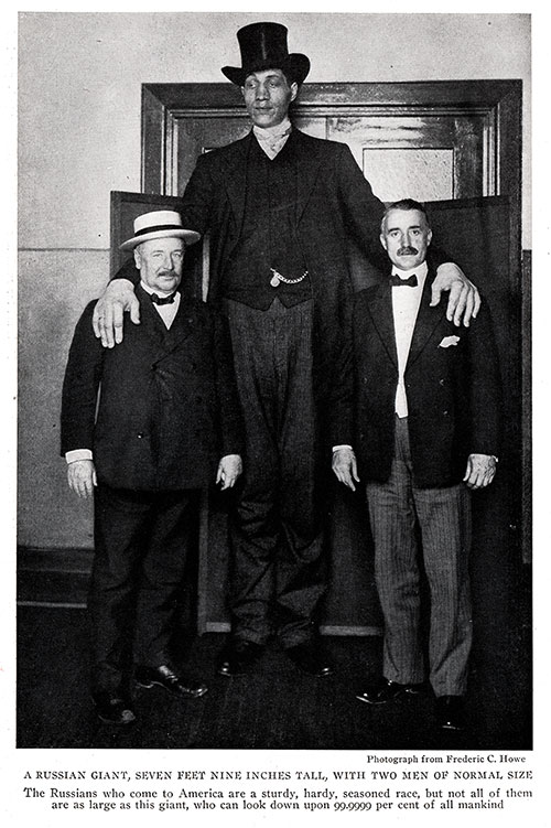 A Giant Russian Immigrant, Seven Feet, Nine Inches Tall, Shown Here with Two Men of Normal Size.
