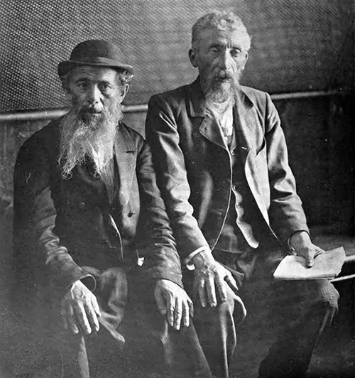 Two Male Immigrants Wait in the Detention Pen - Men Who Will Be Deported as Not Desirable.