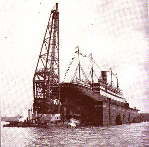The Ocean Liner SS Nieuw Amsterdam in Drydock, with Wilton's Floating Crane "Titan" in Attendance.