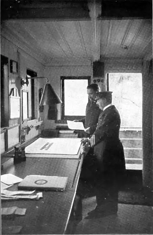 An Inspector Visits the Chart-Room with the Captain to Examine the Record of the Deviation of the Compasses.