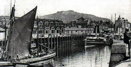 Busy Harbor Scene at Cherbourg Showing Tenders in the Foreground and the Passenger Train Station in the Background.