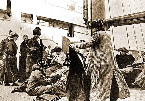 Titanic Survivors are comforted and supplied with steamer rugs on the deck of the Carpathia - 15 April 1912.