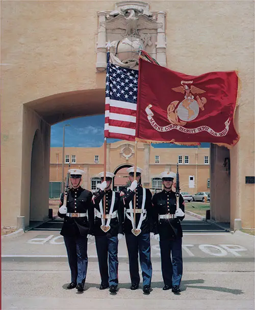 Four Marines in Parade Dress Carrying the US Flag and Flag of the USMC, Standing Outside San Diego MCRD.