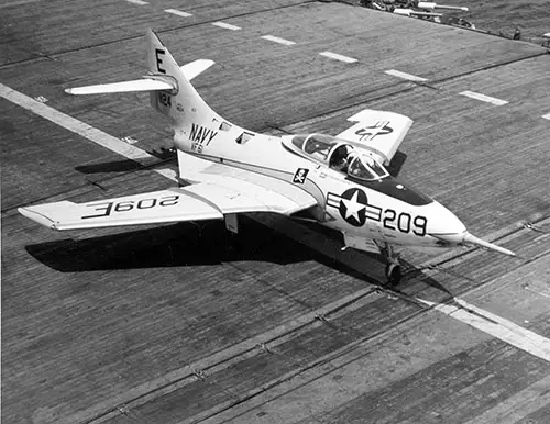 Grumman F9F-8 Cougar Fighter Plane. BUNO 141124 of Fighter Squadron 61 (VF-61) on the flight deck of USS INTREPID (CVA-11), 25 April 1956. Note the squadron insignia under the cockpit. Photographer, PM1 Wilcox.