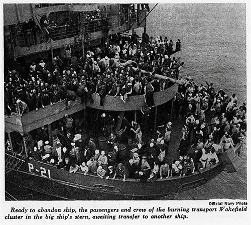 Ready to abandon ship, the passengers and crew of the burning transport Wakefield cluster in the big ship's stern