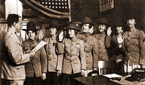 Dressed in Men's Uniforms, (l to R) Violet Van Wagner, Marie Schlight, Florence Wiedinger, Isabelle Balfour, Janet Kurgan, Edith Barton, and Helen Dupont Are Sworn in as Privates at New York.