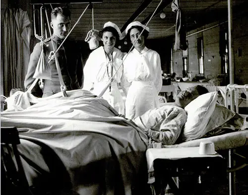 Patient at the Camp Pike Orthopedic Ward being Attended to by the Orthopedic Surgeon and Two Nurses. nd, c. 1918.