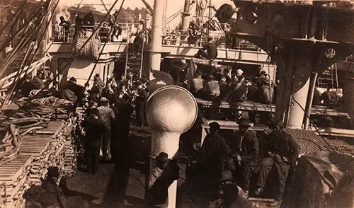 You can see the Band on he Lefthand Side of the Photograph. We have a Concert Every Noon as Sea. Some Stevedores are Visible in the Foreground.